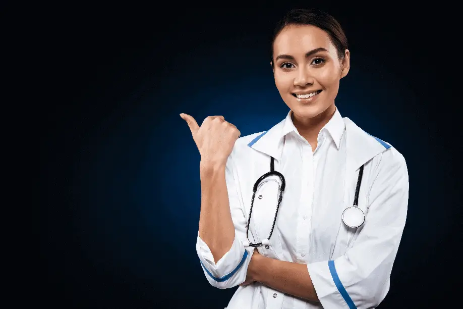 A healthcare professional in Athens, GA in a white coat with a stethoscope around the neck points to the left against a dark blue background.